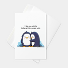 Front view of a greeting card featuring an original illustration of two penguins cozying up together, one of them saying “I like you a lottle. It’s like a little, except a lot.” on a white background.